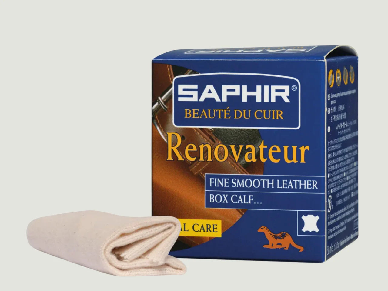 Frasco de Saphir Renovateur Crema con paño de algodón, tratamiento suave y nutritivo para cuero fino. Limpia, hidrata y protege sin dejar residuos grasos.